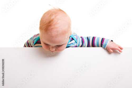 Isolated beaufiful caucasian infant baby behind whiteboard
