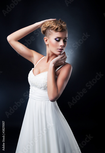 Portrait of romantic blonde young bride. Studio shot