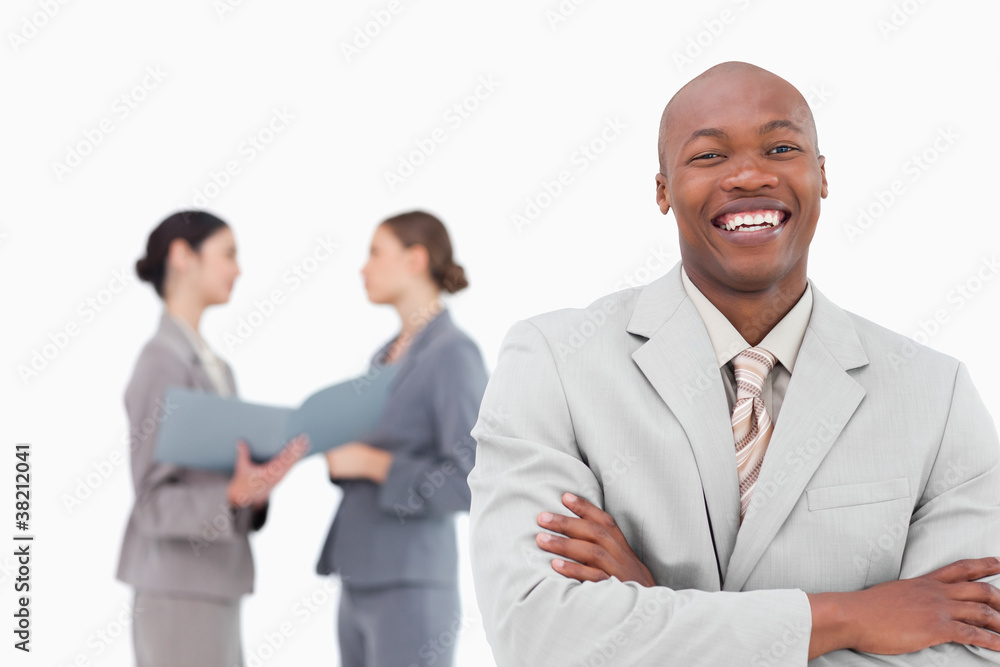 Laughing tradesman with colleagues behind him Laughing tradesman with colleagues behind him