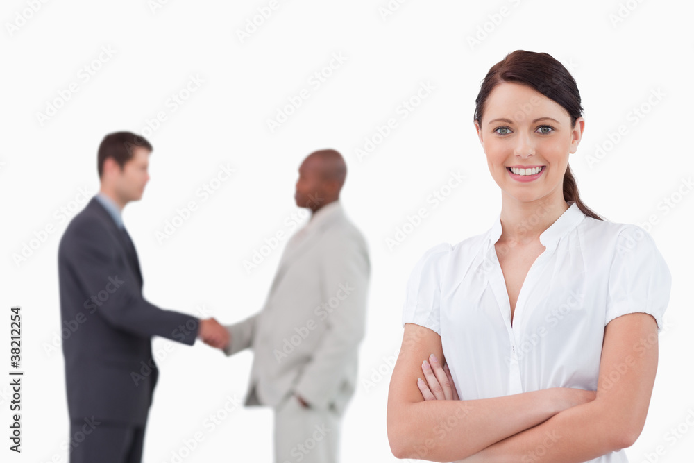 Businesswoman with arms folded and hand shaking trading partners Businesswoman with arms folded and hand shaking trading partners
