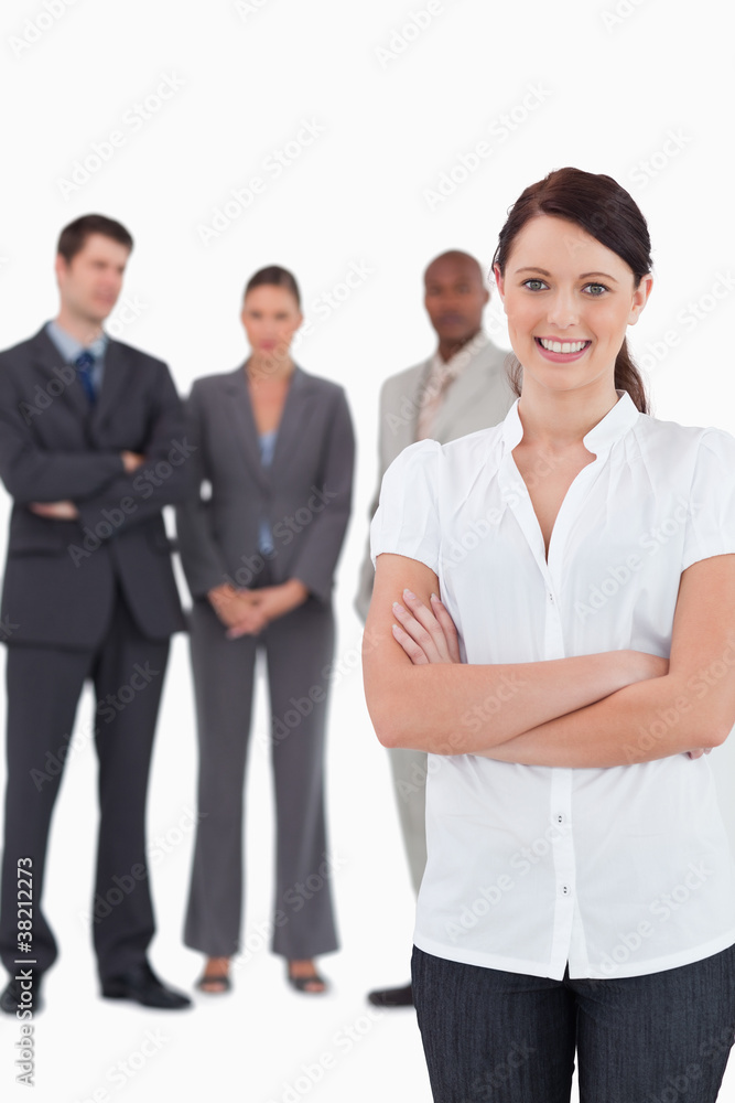Businesswoman with arms folded and three colleagues behind her Businesswoman with arms folded and three colleagues behind her