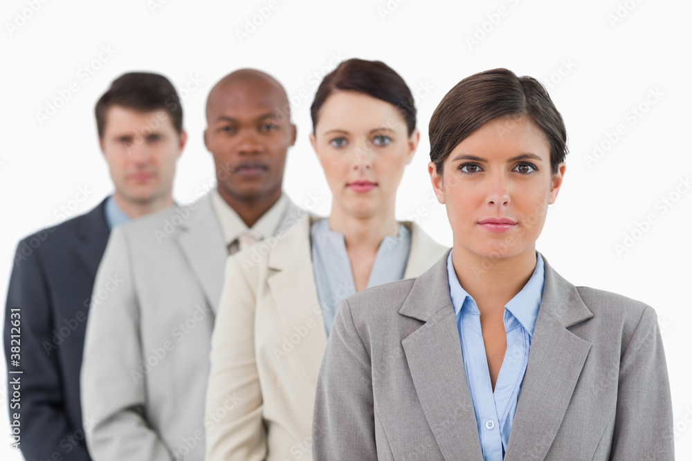 Serious looking salesteam standing together Serious looking salesteam standing together