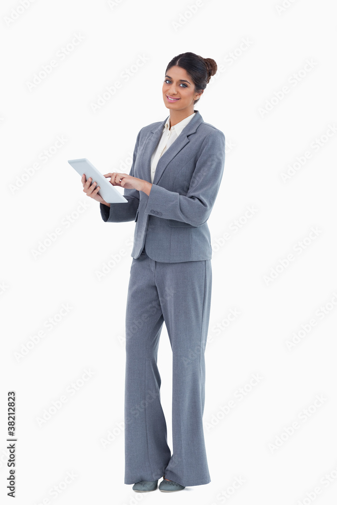 Smiling saleswoman using tablet
