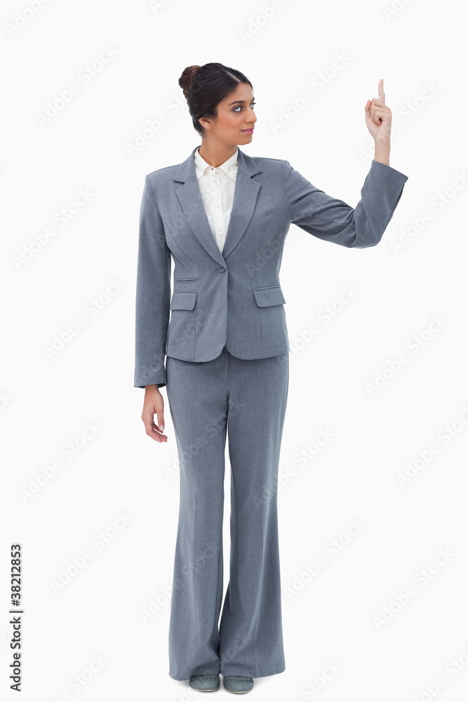 Businesswoman looking at hand while pointing up Businesswoman looking at hand while pointing up