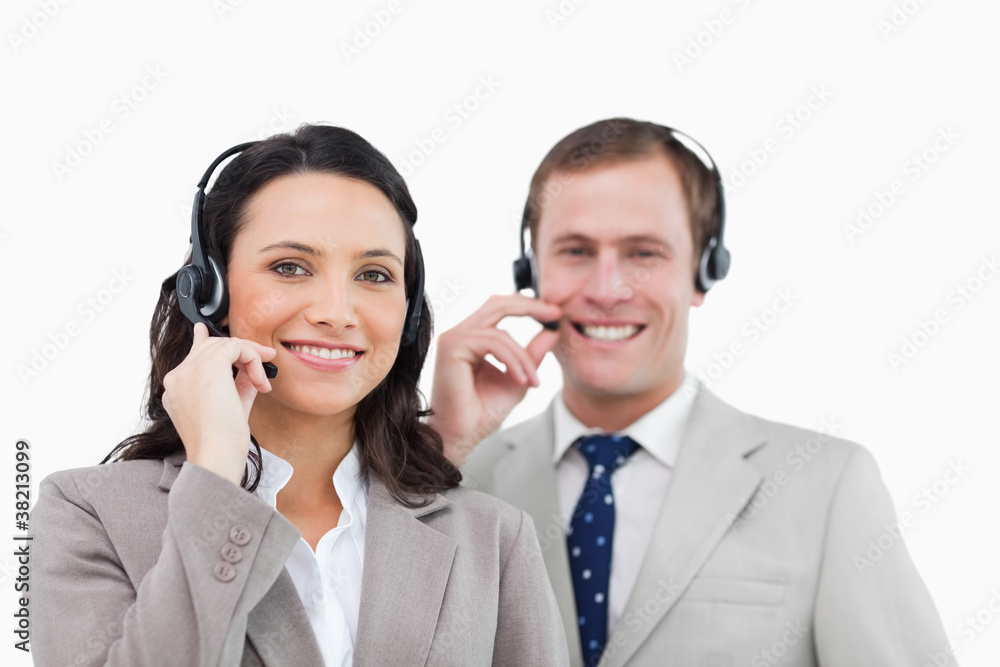 Smiling call center team with their headsets Smiling call center team with their headsets