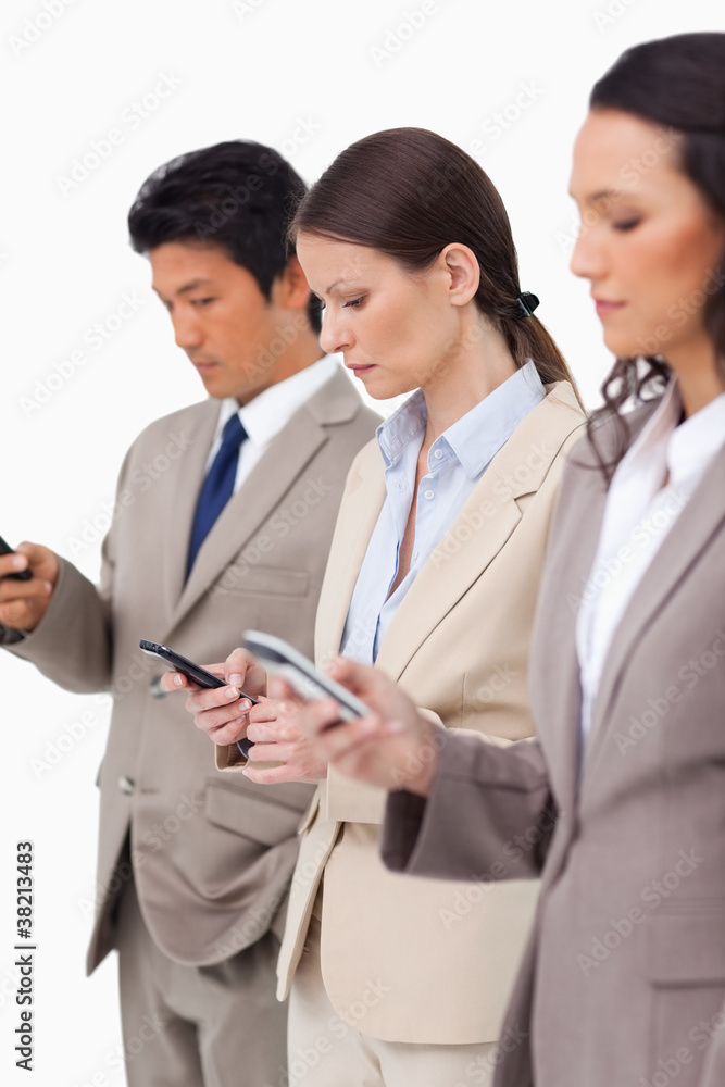 Group of businesspeople with their cellphones Group of businesspeople with their cellphones