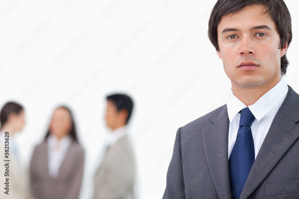 Young businessman with team behind him Young businessman with team behind him