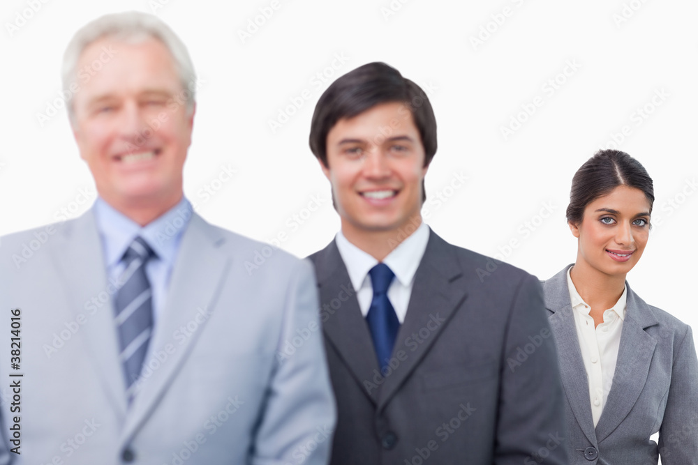 Smiling mature businessman with his employees Smiling mature businessman with his employees