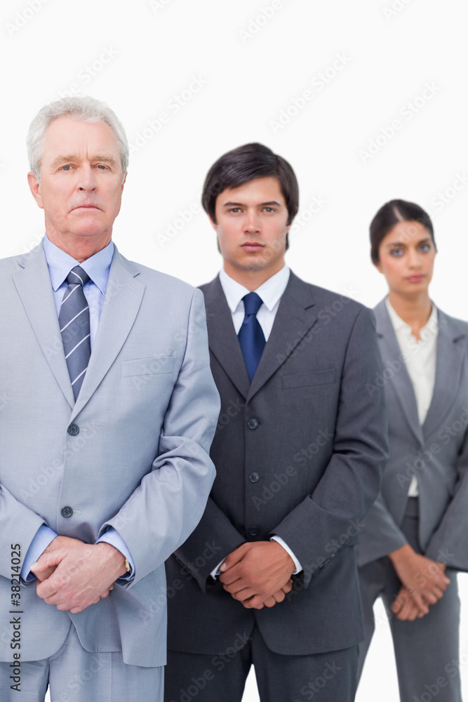 Mature tradesman standing with his employees Mature tradesman standing with his employees