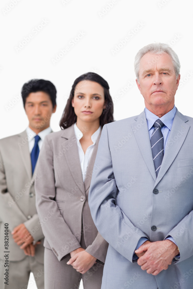 Mature salesman with his young employees Mature salesman with his young employees