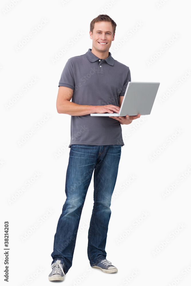 Smiling young man working on his notebook Smiling young man working on his notebook