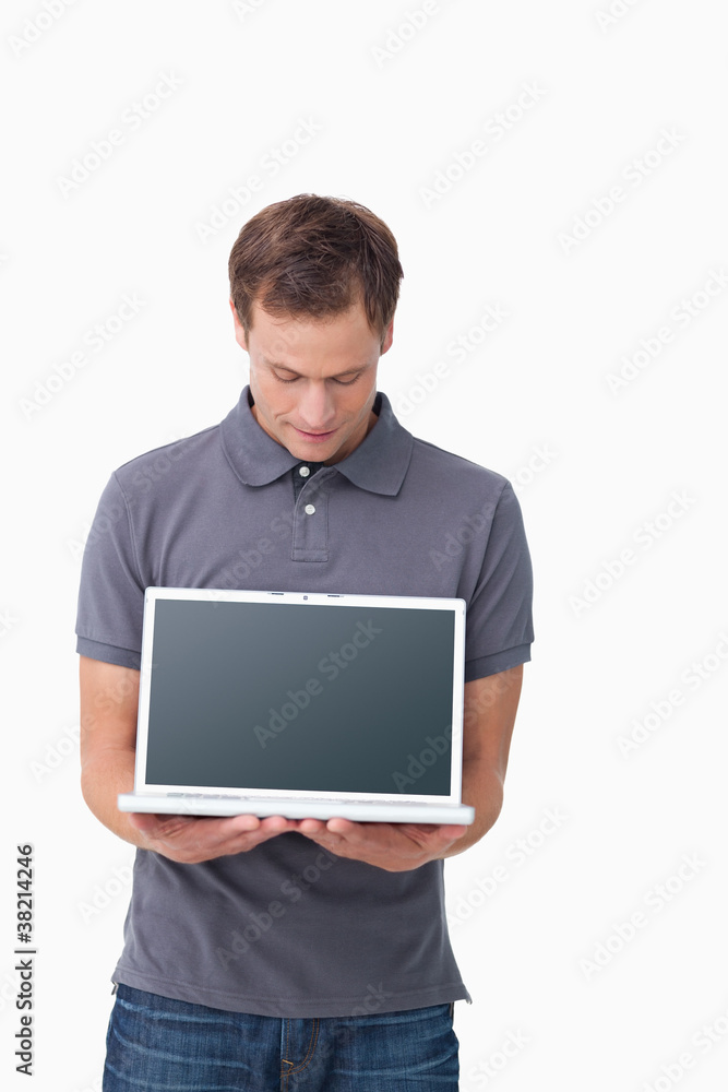 Young man showing screen of his notebook Young man showing screen of his notebook