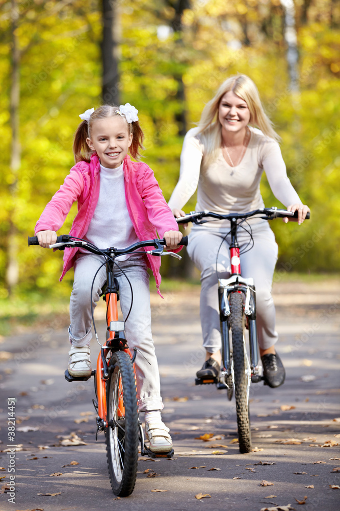 Fototapeta premium Mother and daughter on bicycle