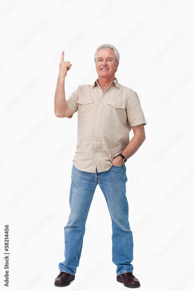 Smiling mature male pointing up Smiling mature male pointing up