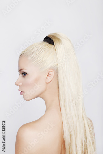 Portrait of the beautiful blonde woman with a long tail.