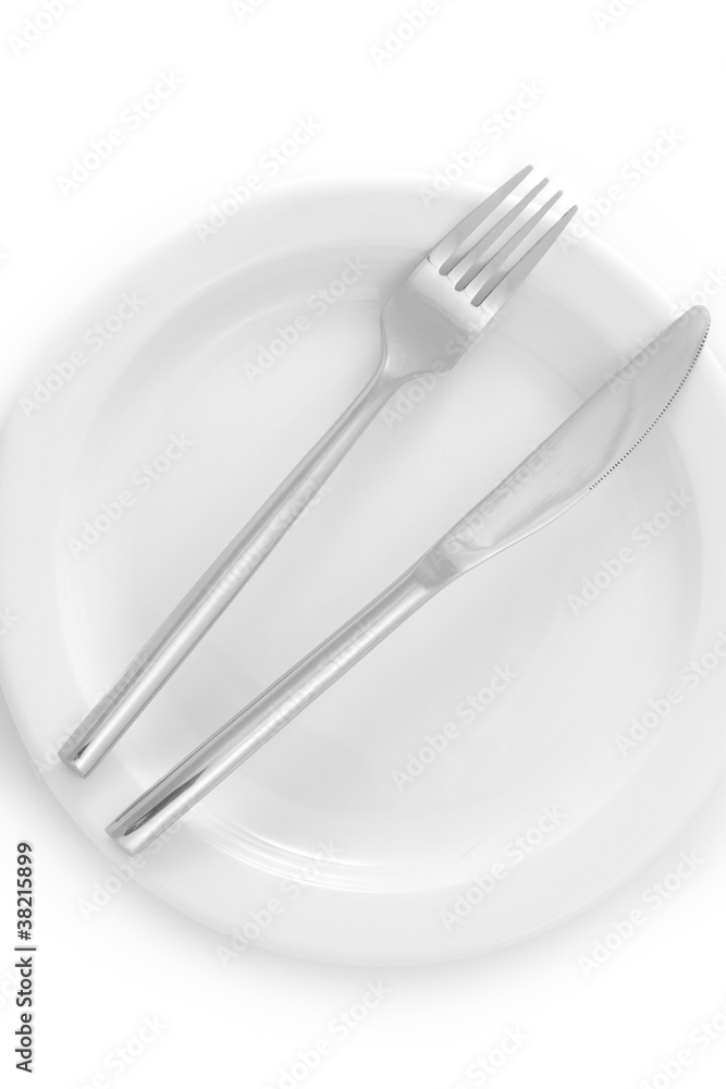 White empty plate with fork and knife isolated on white White empty plate with fork and knife isolated on white