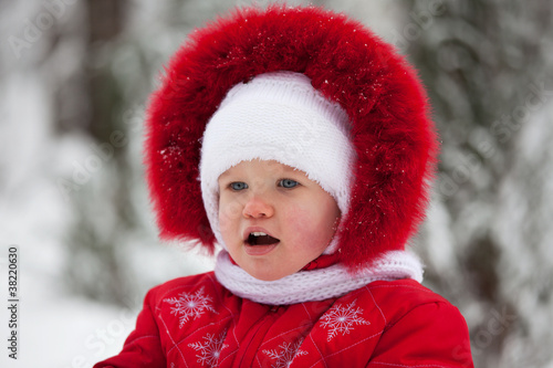 Little girl in a red winter suit