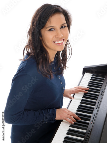 smiling teenage girl playing piano