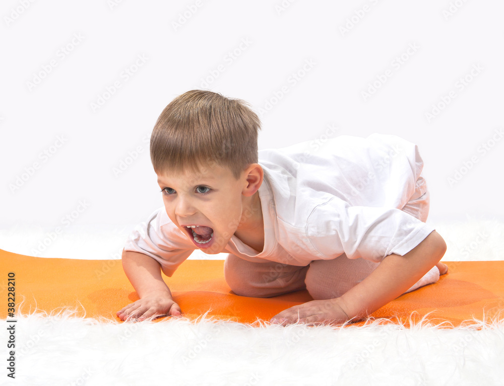 Children's yoga. The little boy does exercise. Children's yoga. The little boy does exercise.