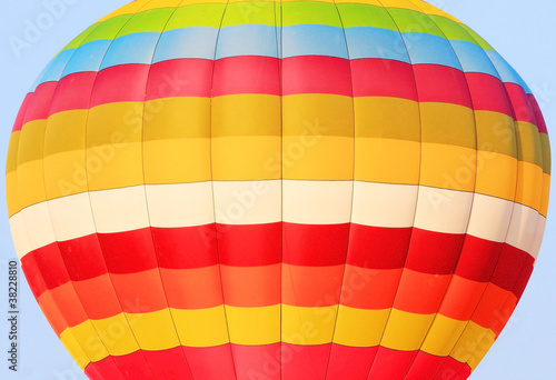 close up of colorful hot air balloon isolated on blue sky