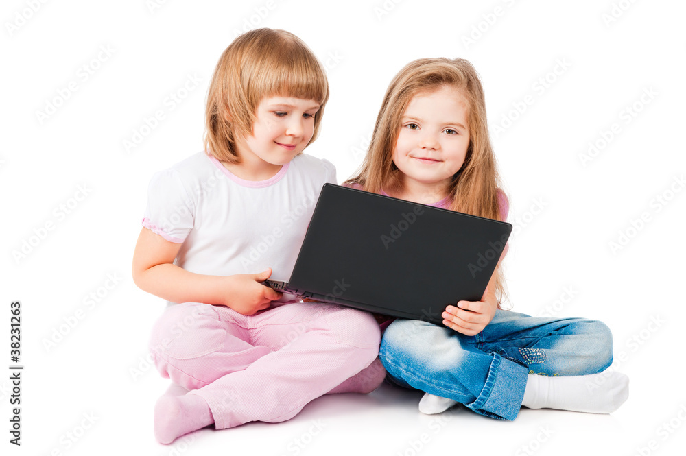 two smiling girls looking at laptop two smiling girls looking at laptop
