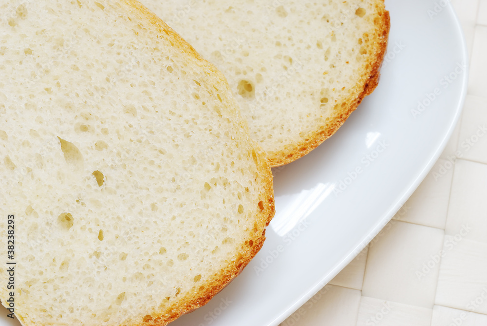 Close-up of bread slices in the plate, top view