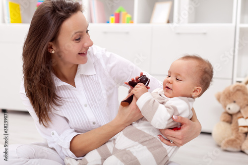 Young mother playing with her baby girl