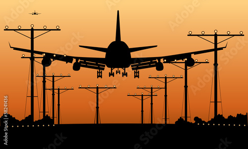 airliner landing at sunset