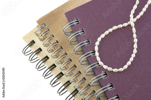 Pearl neaklace decoration on notebook photo
