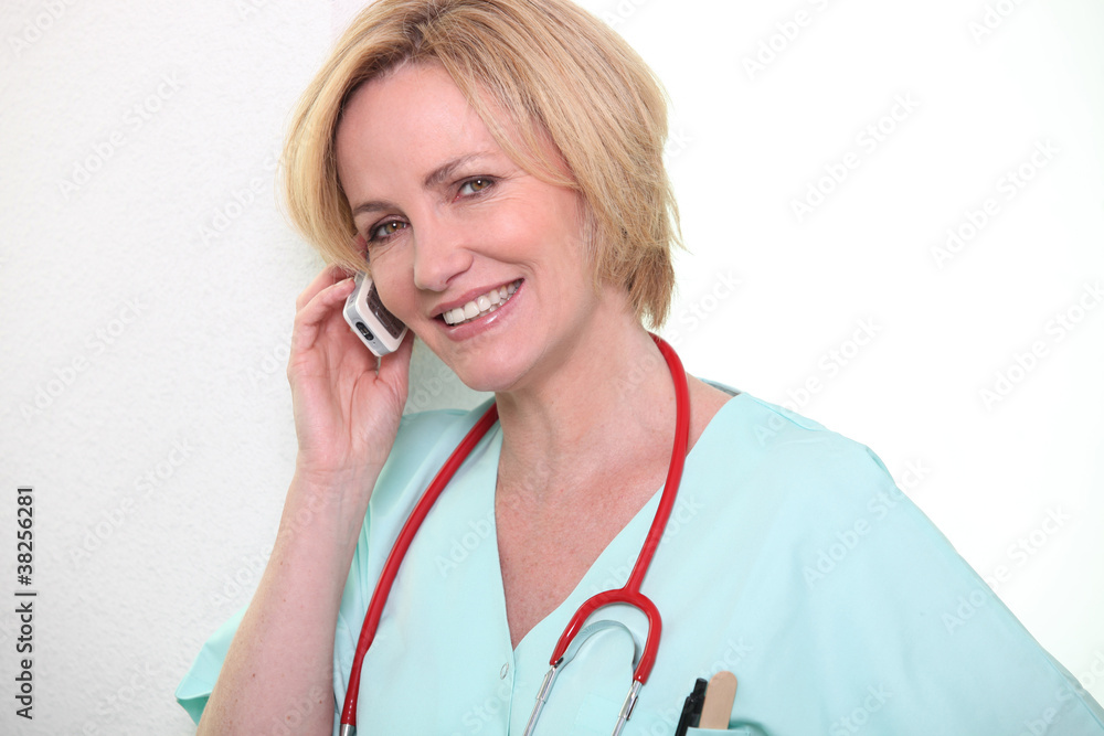 Female nurse speaking on mobile telephone