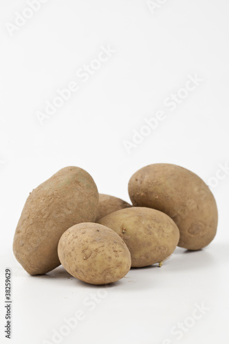 Raw potatoes in burlap bag isolated