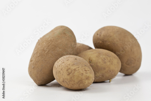 Raw potatoes in burlap bag isolated