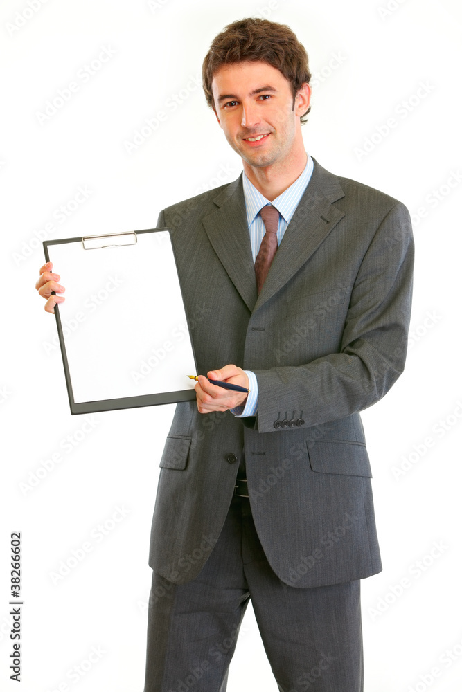 Smiling modern businessman giving clipboard for you to sign Smiling modern businessman giving clipboard for you to sign