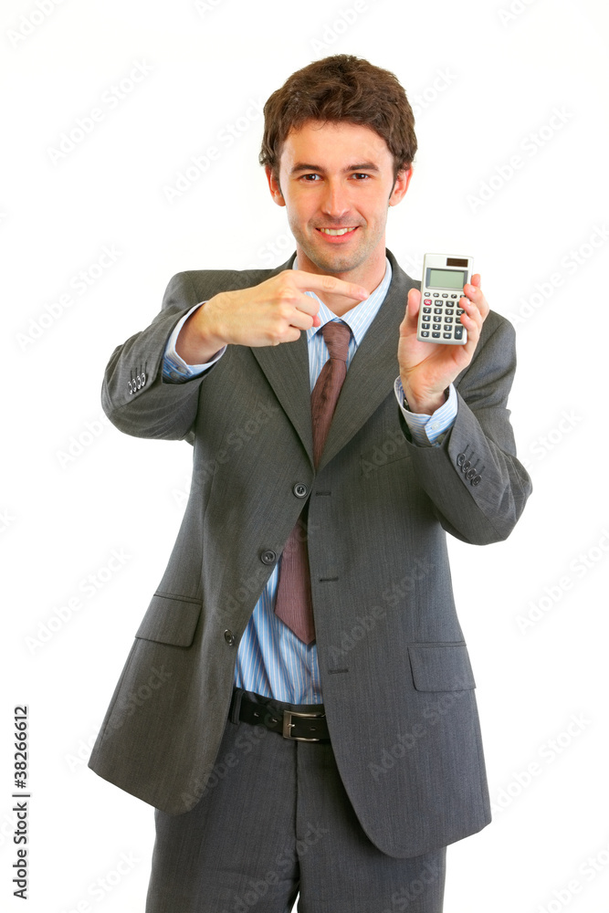 Smiling modern businessman pointing finger on calculator Smiling modern businessman pointing finger on calculator