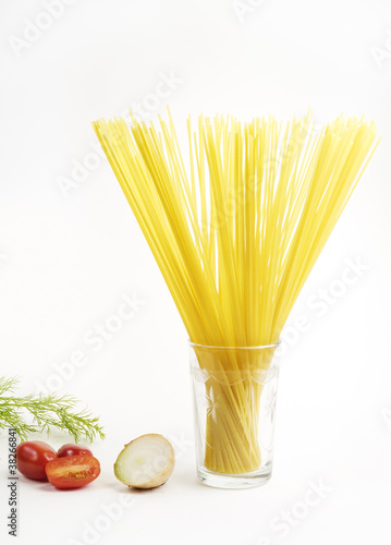 Italian noodles, spaghetti, tomatoes and onion