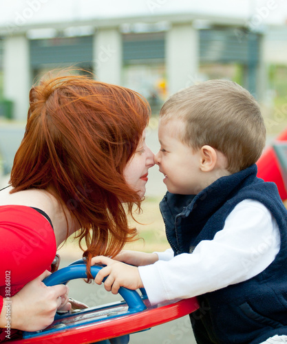 Mother and son on playground. Children send a thoughts.