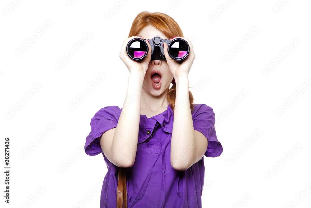 Teen redhead girl with binoculars isolated on white background