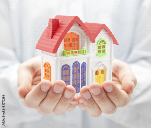 Colorful house in hands