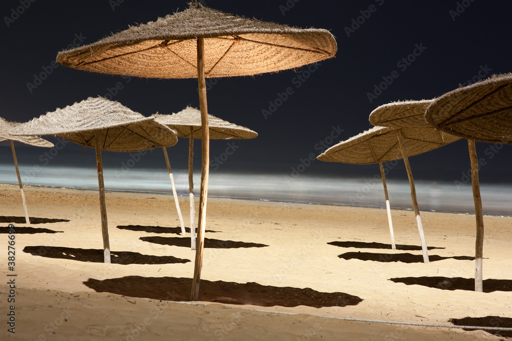 Umbrellas at a beach at night
