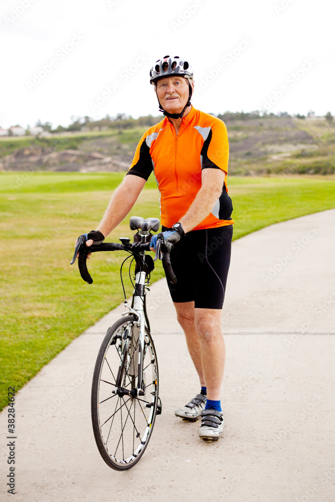 Fototapeta premium senior man standing by his road bicycle