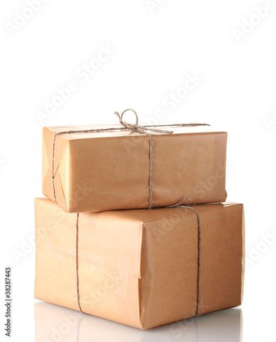 Two parcels wrapped in brown paper tied with twine arranged in