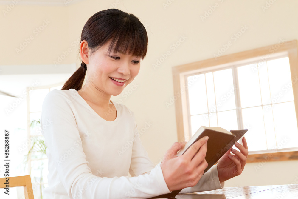 Beautiful asian woman reading a book Beautiful asian woman reading a book