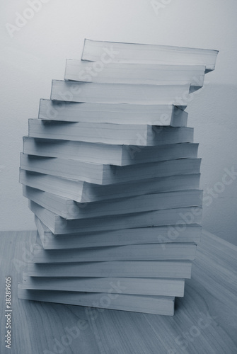 Stack of book in office desktop. Close up paper's pages.