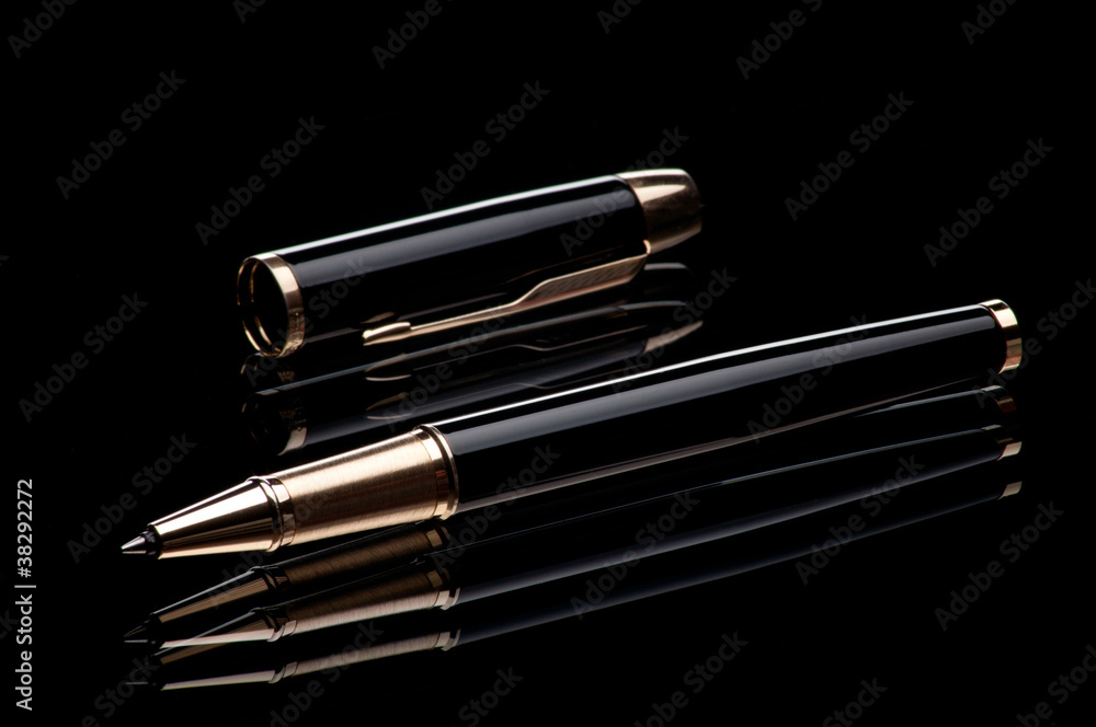 Ballpoint pen and cover on a black mirror background Ballpoint pen and cover on a black mirror background