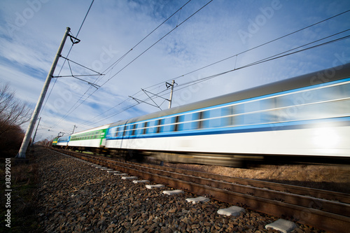 Fast train passing under a bridge on a lovely summer day