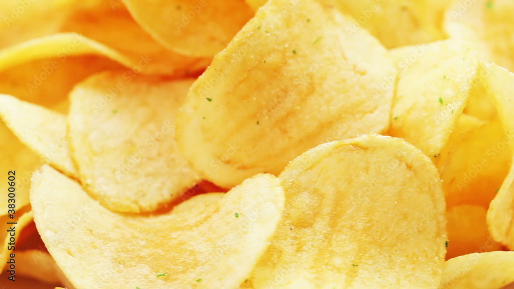 Rotating potato chips, macro view food background Rotating potato chips, macro view food background