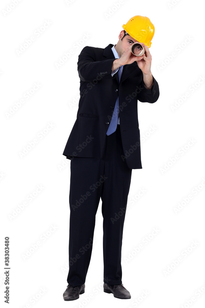businessman using a blueprint as a binoculars businessman using a blueprint as a binoculars