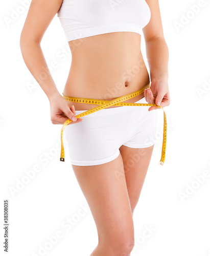 Woman measuring her slim body isolated on white background
