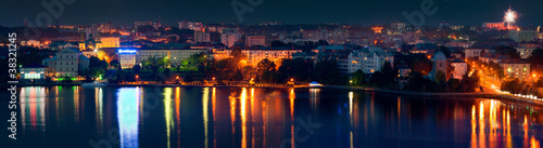 Ternopil city night skyline panorama over lake with colorful ref