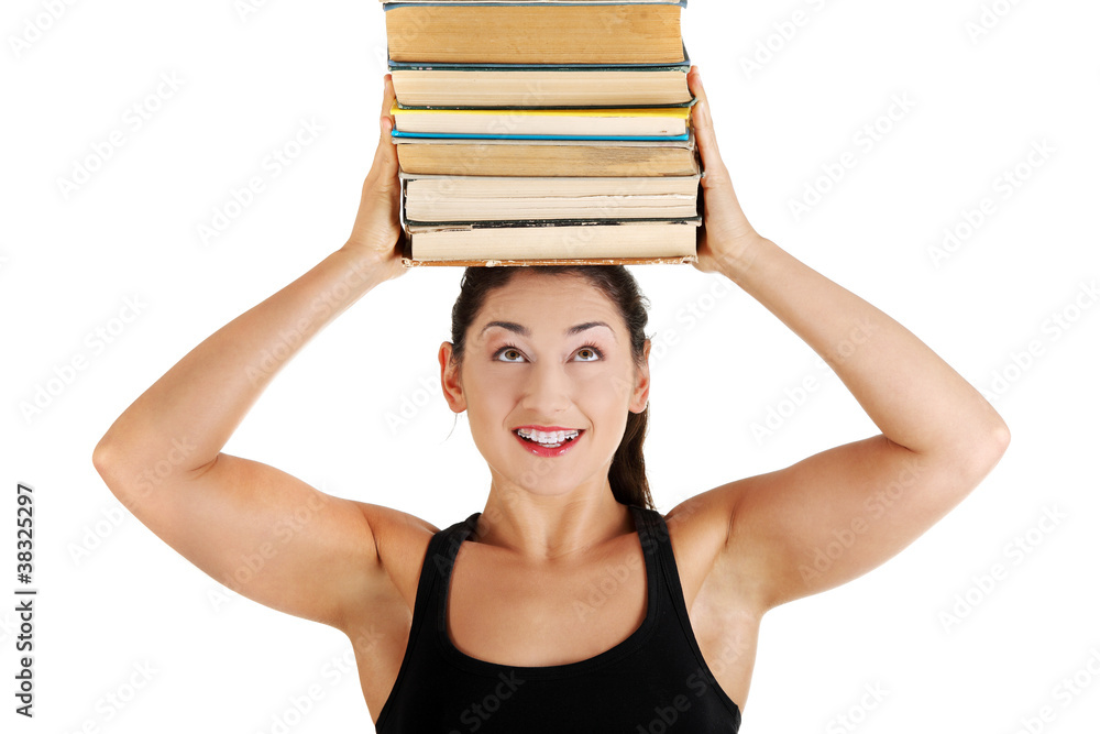 Young woman (student) with books on her head Young woman (student) with books on her head